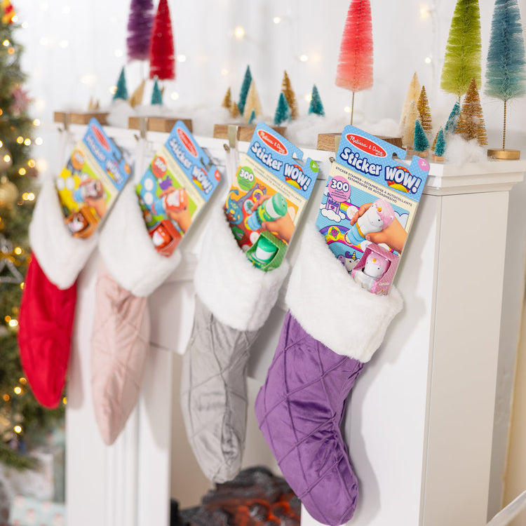 Melissa & Doug Best Holiday Stocking Stuffers & Small Gifts for Kids blog post stockings hung on a mantle at Christmas