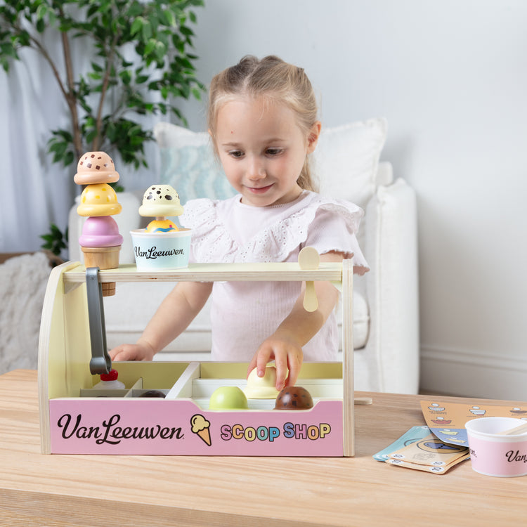 A kid playing with The Van Leeuwen Scoop Shop Ice Cream Play St