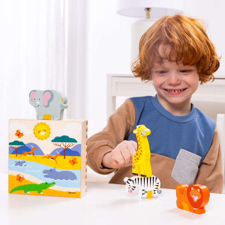 A kid playing with The Melissa & Doug Safari Animal Matching Wooden Toddler Toy Play Set Ages 2+