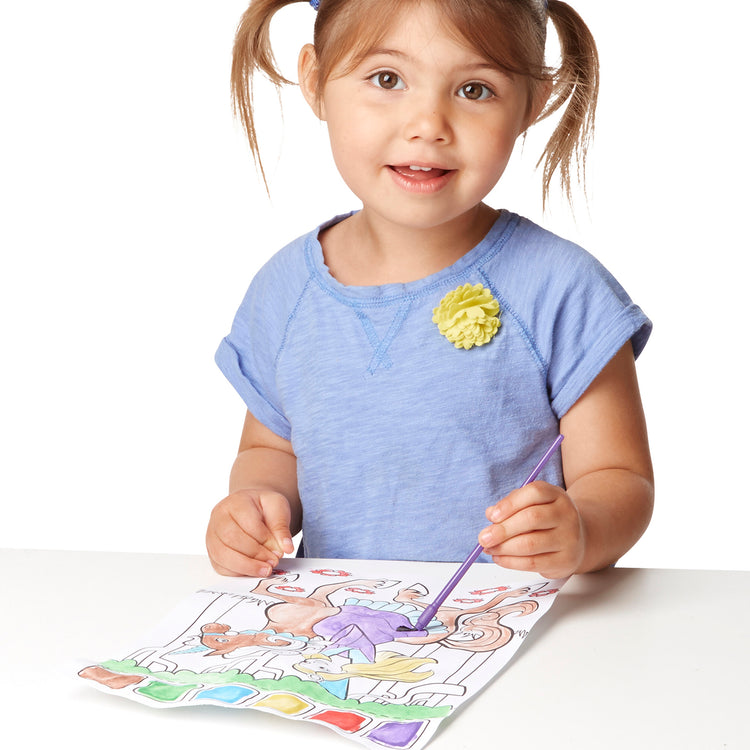 A child on white background with The Melissa & Doug Paint With Water - Princess, 20 Perforated Pages With Spillproof Palettes