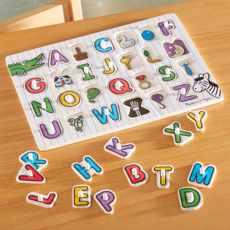 A playroom scene with The Melissa & Doug Lift & See Alphabet Wooden Peg Puzzle (26 pcs)