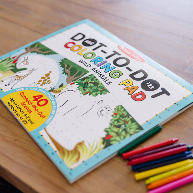 A kid playing with The Melissa & Doug ABC 123 Dot-to-Dot Coloring Pad – Wild Animals (40 Pages)