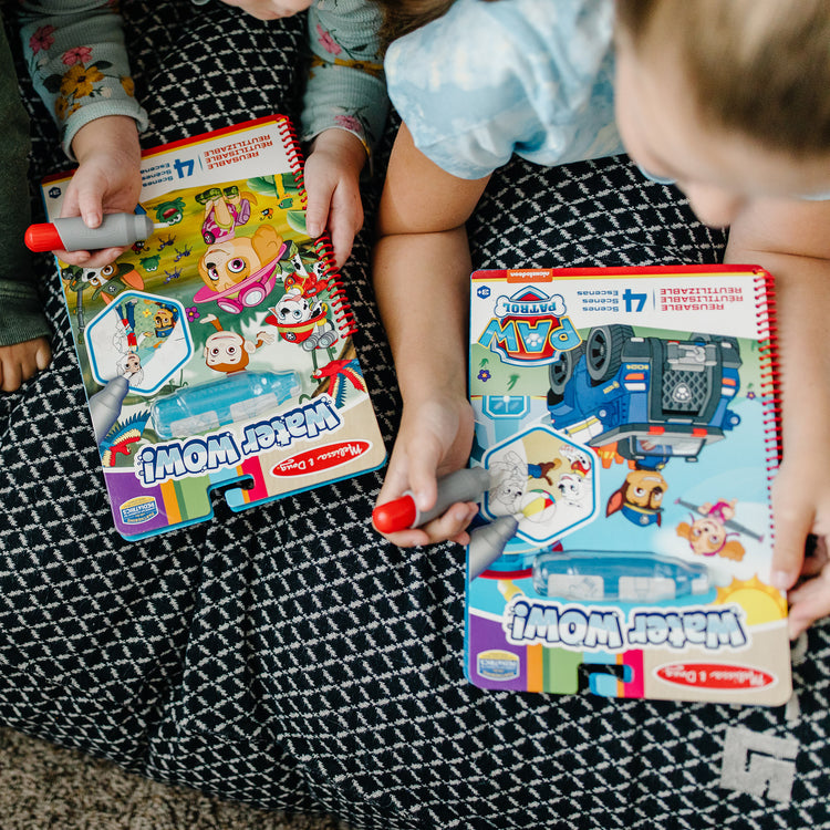 A kid playing with The Melissa & Doug PAW Patrol Water Wow! - Chase Water Reveal Travel Activity Pad