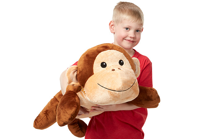 A child on white background with The Melissa & Doug Cuddle Monkey Jumbo Plush Stuffed Animal with Activity Card