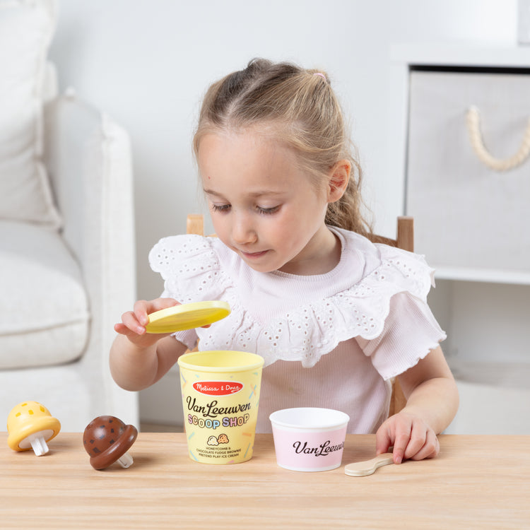 A kid playing with The Van Leeuwen Scoop Shop Ice Cream Play St