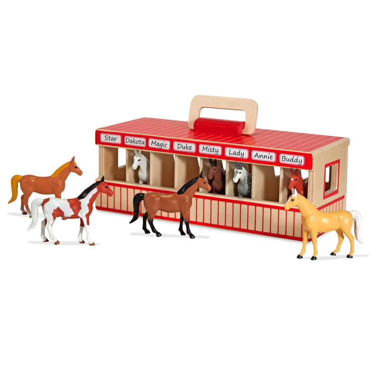 The front of the box for The Melissa & Doug Take-Along Show-Horse Stable Play Set With Wooden Stable Box and 8 Toy Horses