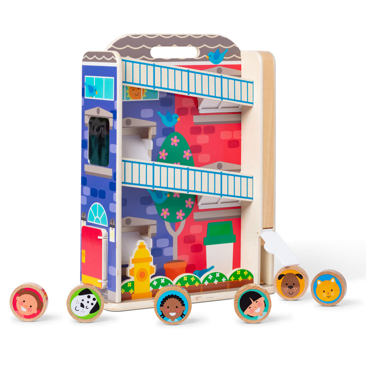 The loose pieces of The Melissa & Doug GO Tots Wooden Town House Tumble with 6 Disks