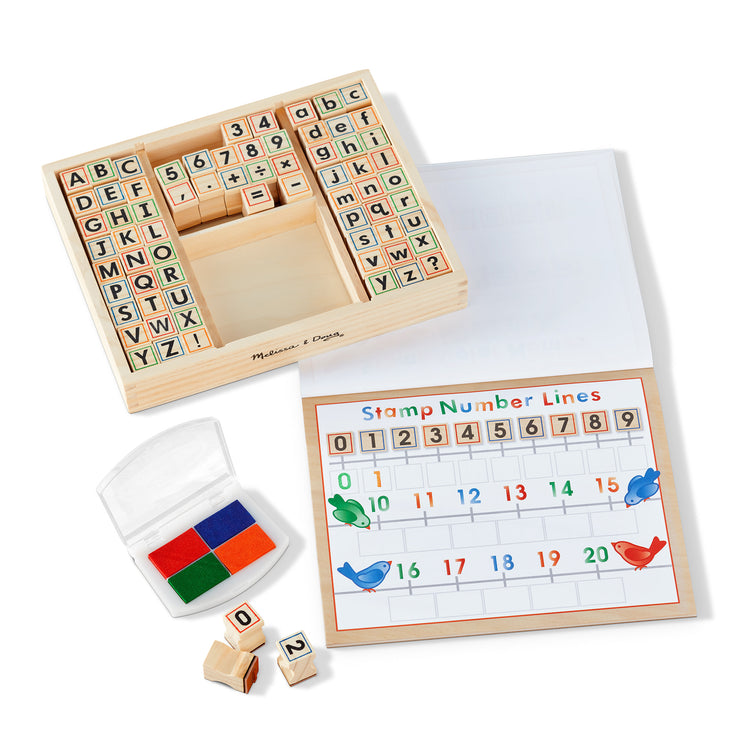 A playroom scene with The Melissa & Doug Deluxe Letters and Numbers Wooden Stamp Set ABCs 123s With Activity Book, 4-Color Stamp Pad