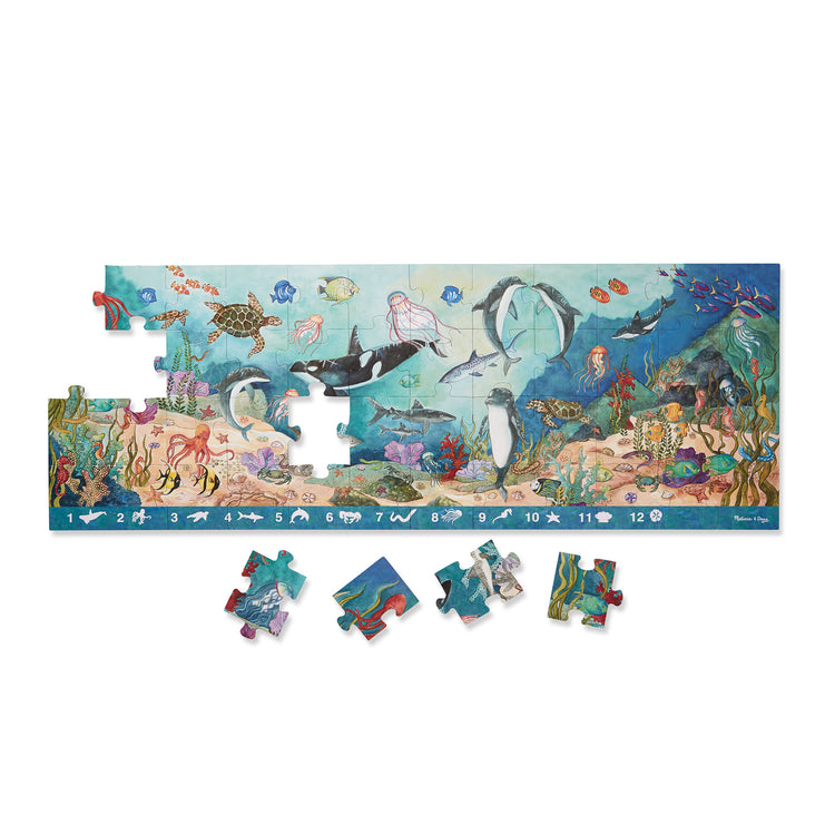 The loose pieces of The Melissa & Doug Search and Find Beneath the Waves Floor Puzzle (48 pcs, over 4 feet long)