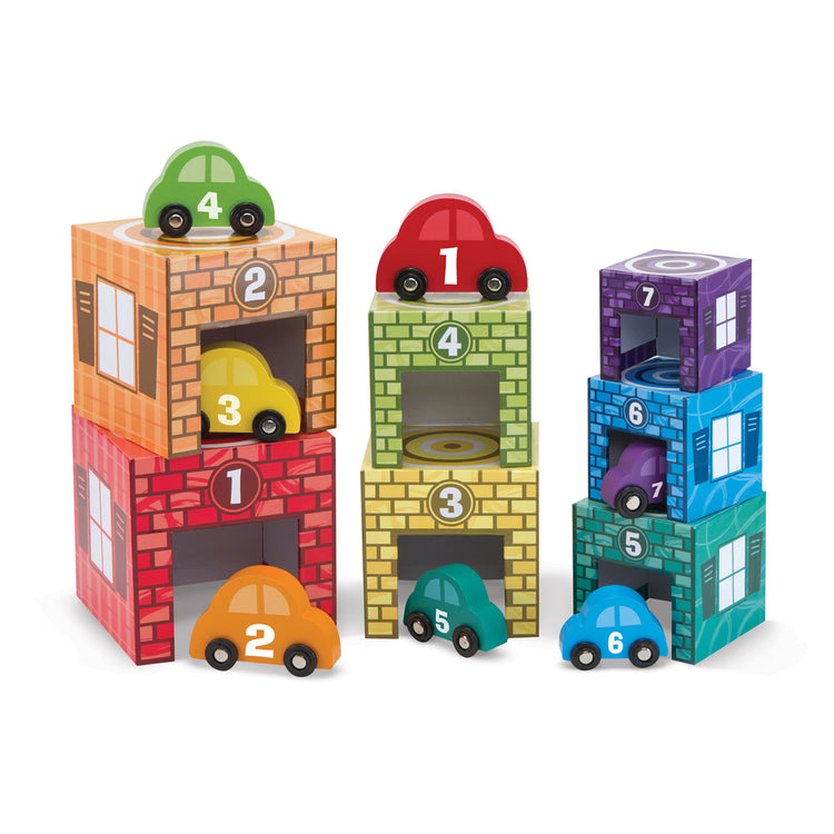 The loose pieces of The Melissa & Doug Nesting and Sorting Garages and Cars With 7 Graduated Garages and 7 Stackable Wooden Cars