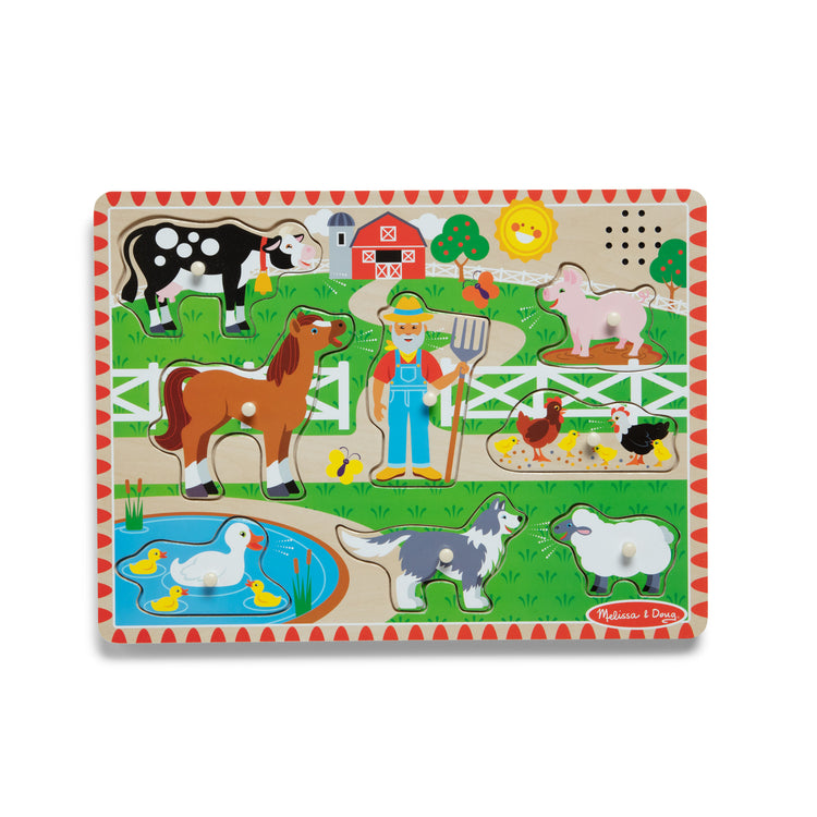 A kid playing with The Melissa & Doug Old MacDonald's Farm Sound Puzzle