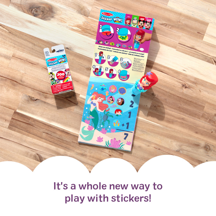 A kid playing with The Melissa & Doug Sticker Wow!™ Disney Princess Ariel Bundle: 24-Page Activity Book, Refillable Sticker Stamper, Mini Pad, 500 Stickers, Arts and Crafts for Kids Ages 3+