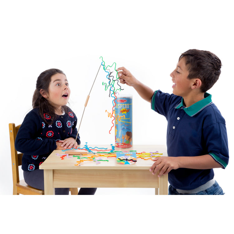 A child on white background with The Melissa & Doug Suspend Junior Family Game (31 pcs)