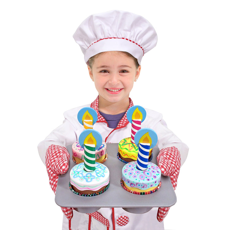 A child on white background with The Melissa & Doug Bake and Decorate Wooden Cupcake Play Food Set
