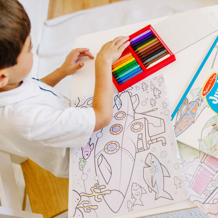 A kid playing with The Melissa & Doug Jumbo Coloring Pad: Vehicles - 50 Pages of White Bond Paper (11 x 14 inches)