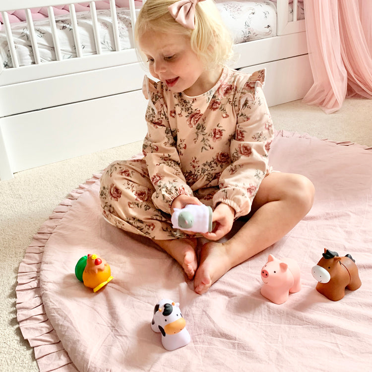 A kid playing with The Melissa & Doug Pop Blocs Farm Animals Educational Baby Toy - 10 Linkable Pieces