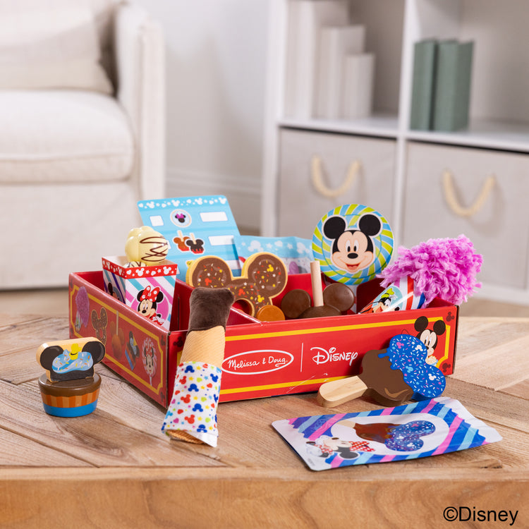 A playroom scene with The Melissa & Doug Disney Snacks & Popcorn Wooden Play Food Set – 24 Pieces | Mickey Mouse, Minnie, Wooden Toy for Boys and for Girls 3+