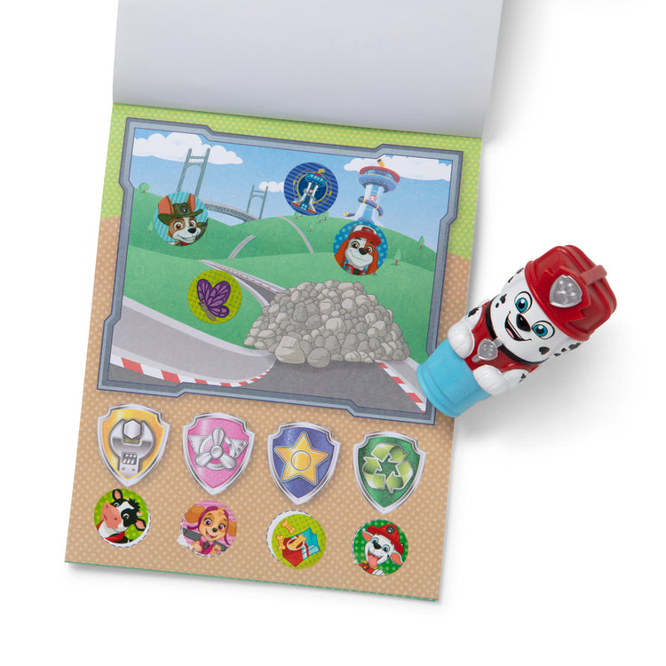The loose pieces of The Melissa & Doug Sticker WOW!™ 24-Page Activity Pad and Sticker Stamper, 300 Stickers, Arts and Crafts Fidget Toy Collectible Character – PAW Patrol Marshall