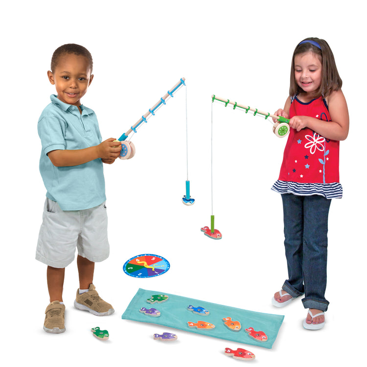A child on white background with The Melissa & Doug Catch & Count Wooden Fishing Game With 2 Magnetic Rods