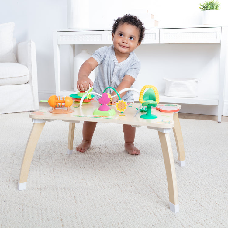 A kid playing with The Farmers Market 3 in 1 Activity Center