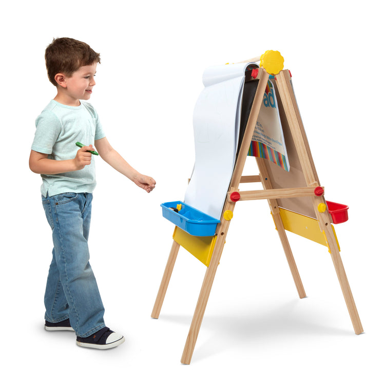 A child on white background with The Melissa & Doug Art Essentials Easel Pad (17 x 20 inches) With 50 Sheets of White Bond Paper