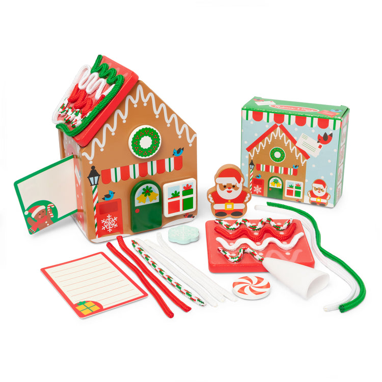 The loose pieces of The Melissa & Doug Gingerbread Holiday Post Office, Reusable Build-and-Decorate Pretend Play Set - Ages 3+