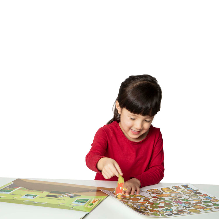 A child on white background with The Melissa & Doug Reusable Sticker Pad: Farm - 280+ Stickers, 5 Scenes