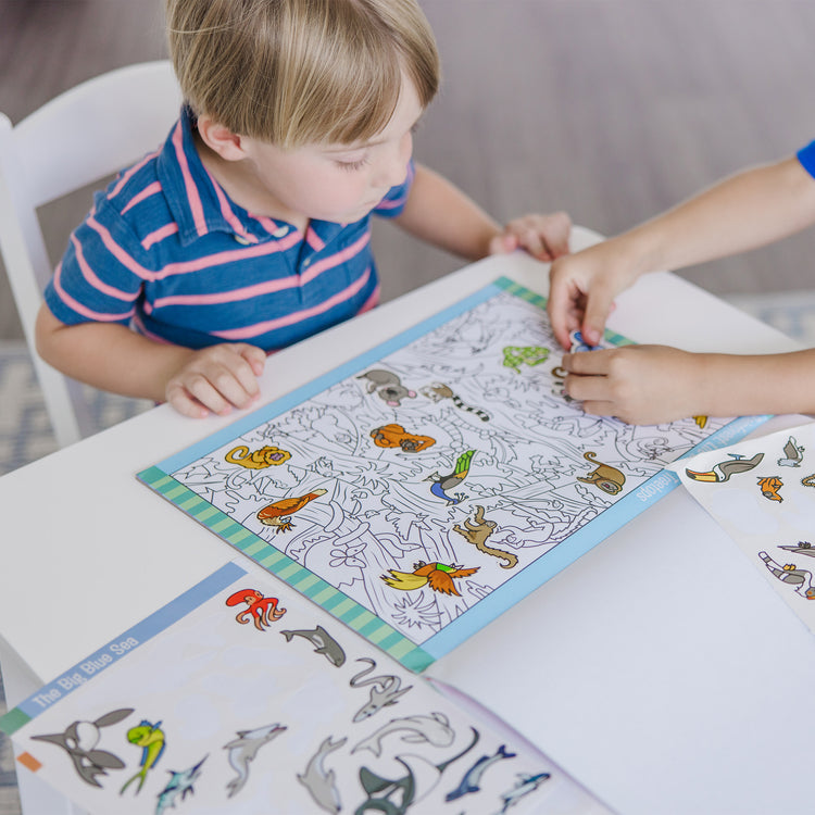 A kid playing with The Melissa & Doug Seek and Find Sticker Pad, Animals (400+ Stickers, 14 Scenes to Color)