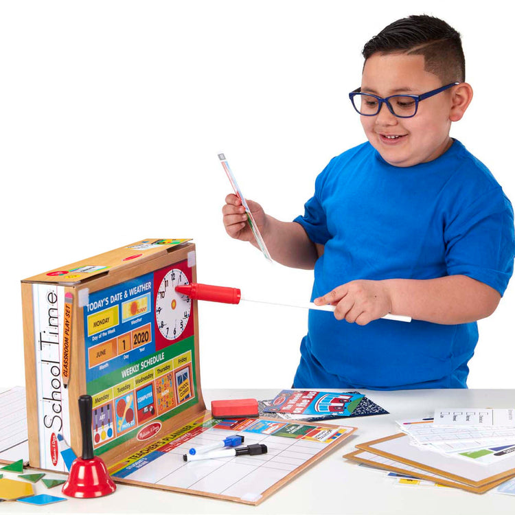 A child on white background with The Melissa & Doug School Time! Classroom Play Set Game - Be Teacher or Student
