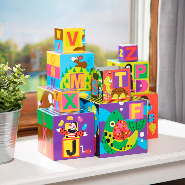 A playroom scene with The Melissa & Doug Deluxe 10-Piece Alphabet Nesting and Stacking Blocks