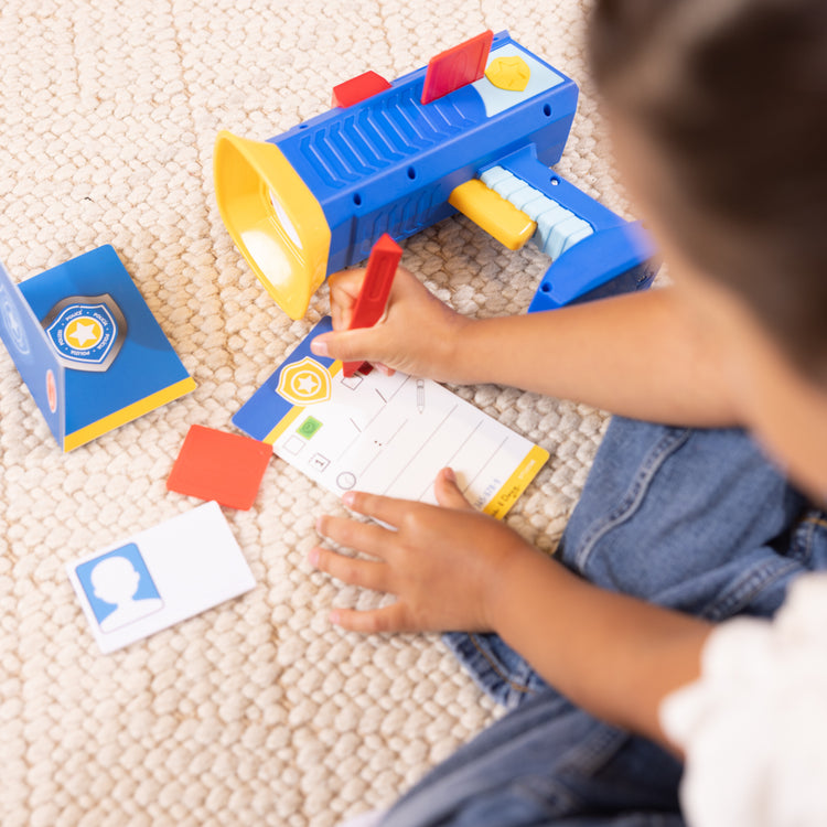 A kid playing with The Police Speed Radar