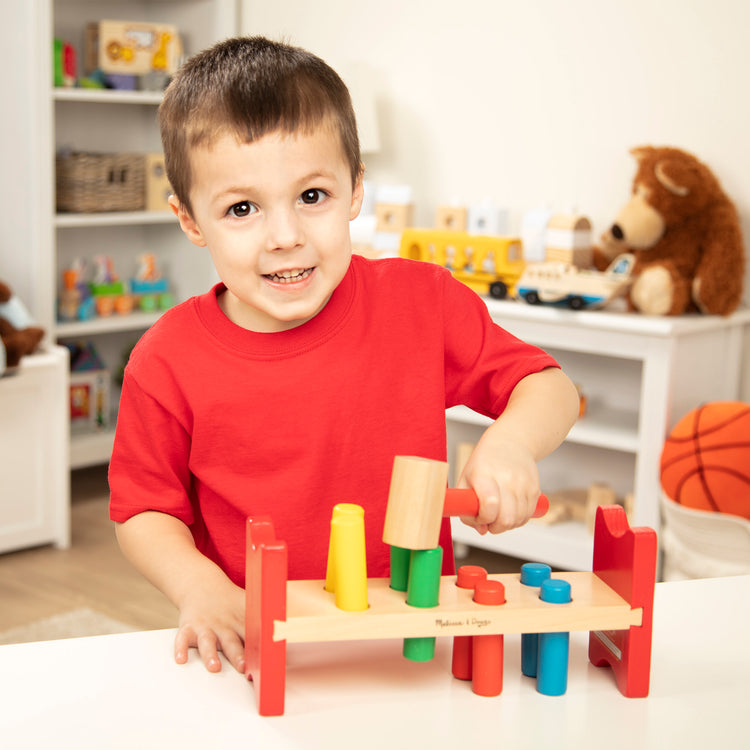 A kid playing with The Melissa & Doug 4 Wooden Classic Rainbow Learning Toys