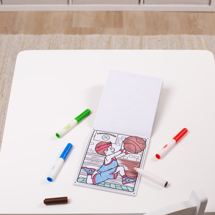 A playroom scene with The Melissa & Doug On the Go Magicolor Coloring Pad: Adventure - 18 Coloring Pages and 4 Markers