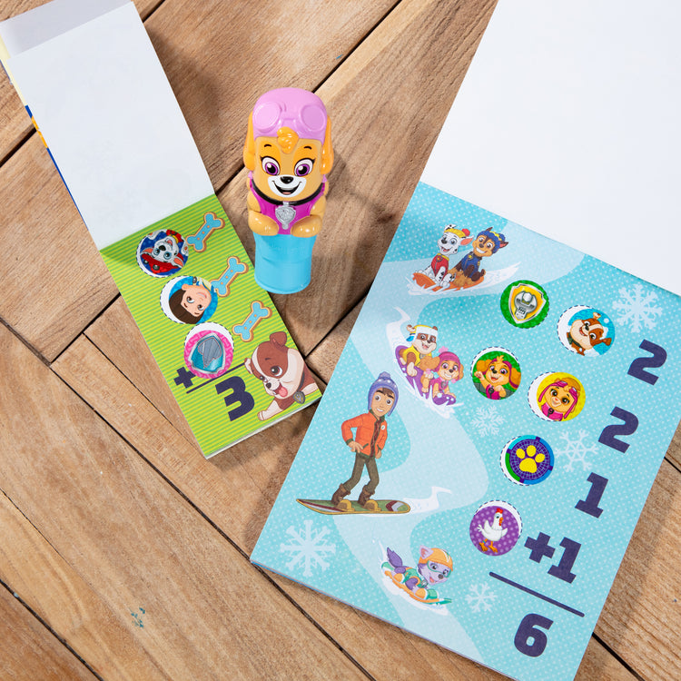 A playroom scene with The Melissa & Doug Sticker WOW!™ PAW Patrol Skye Bundle: 24-Page Activity Pad, Sticker Stamper, 500 Stickers, Mini Pad, Arts and Crafts Fidget Toy Collectible Character