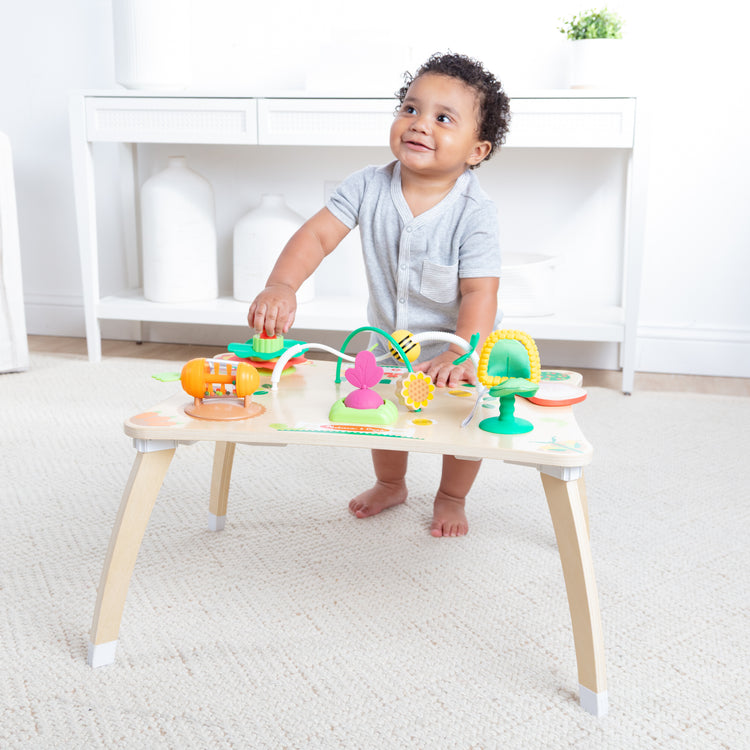 A kid playing with The Farmers Market 3 in 1 Activity Center