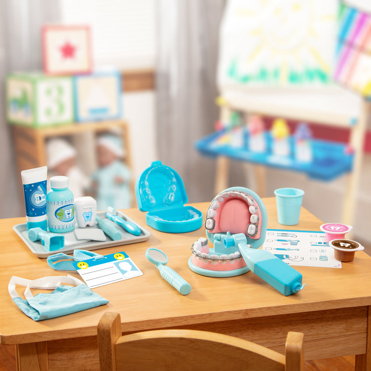 A playroom scene with The Melissa & Doug Super Smile Dentist Kit With Pretend Play Set of Teeth And Dental Accessories (25 Toy Pieces)