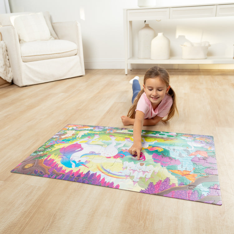 A kid playing with The GID Unicorn Floor Puzzle
