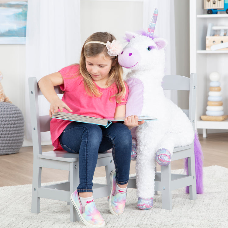 A kid playing with The Melissa & Doug Kids Furniture Wooden Chair Pair - Gray