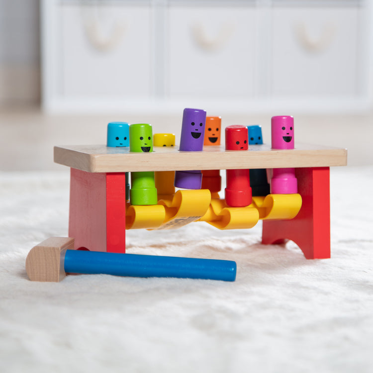 A playroom scene with The Melissa & Doug Deluxe Pounding Bench Wooden Toy With Mallet