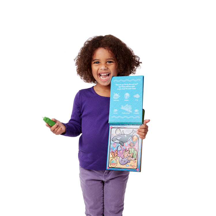 A child on white background with The Melissa & Doug On the Go Water Wow! Reusable Water-Reveal Activity Pads, 2-pk, Vehicles, Animals