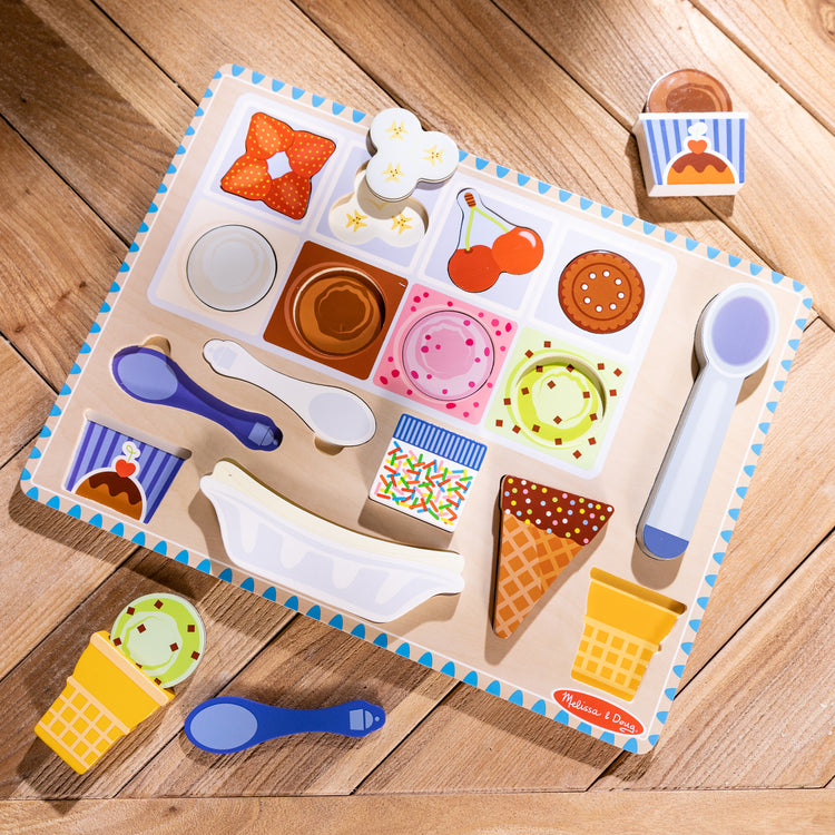 A playroom scene with The Melissa & Doug Ice Cream Wooden Magnetic Puzzle Play Set, 16 Magnet Pieces with Scooper, Wooden Play Food Toy for Boys and for Girls Ages 2+