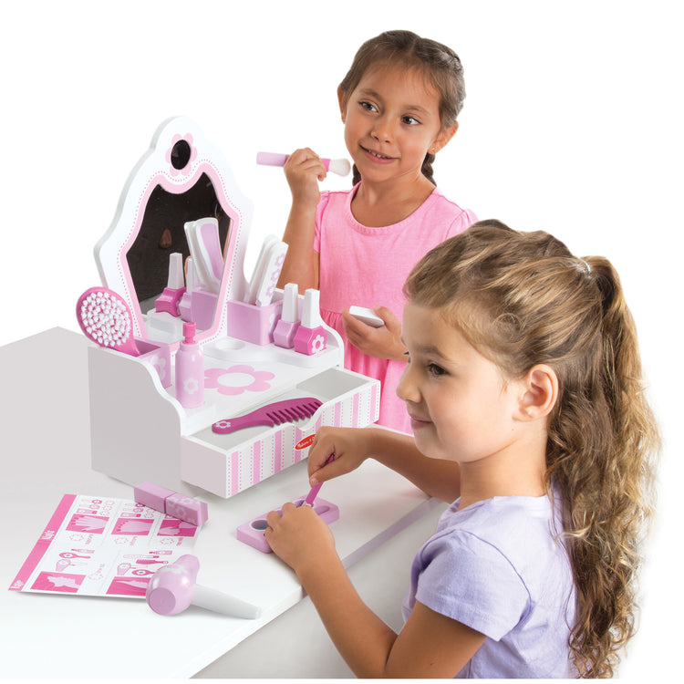 A child on white background with The Melissa & Doug Wooden Beauty Salon Play Set With Vanity and Accessories (18 pcs)