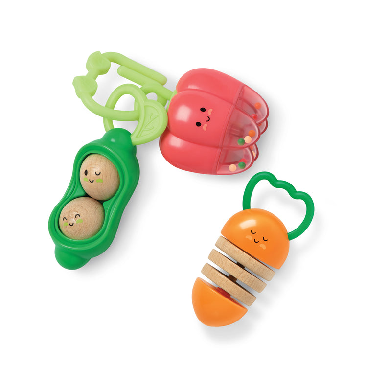 A kid playing with The Farmers Market Veggie Rattles Trio