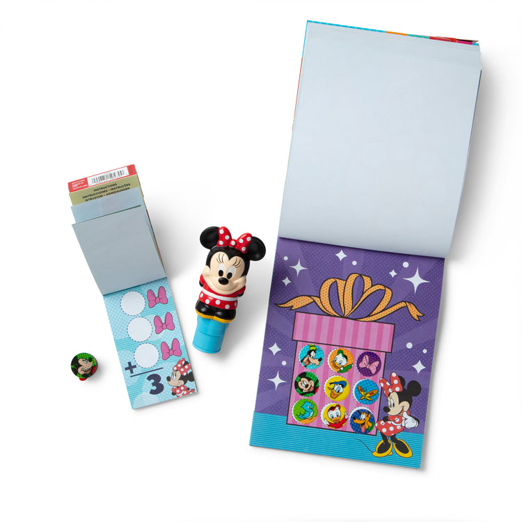 The loose pieces of The Melissa & Doug Sticker WOW!™ Disney Minnie Mouse Bundle: 24-Page Activity Pad, Sticker Stamper, 500 Stickers, Mini Pad, Arts and Crafts Fidget Toy Collectible Character