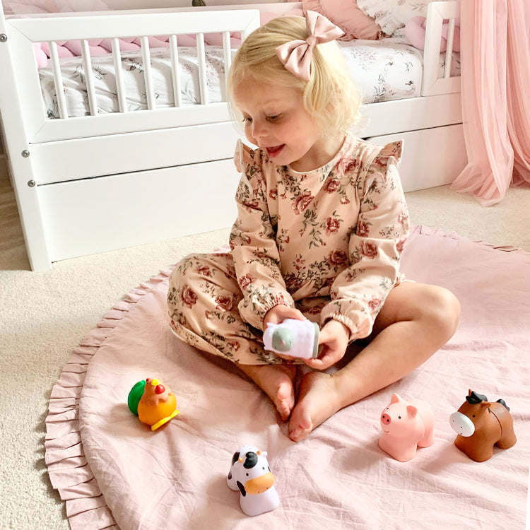 A kid playing with The Melissa & Doug Pop Blocs Farm Animals Educational Baby Toy - 10 Linkable Pieces