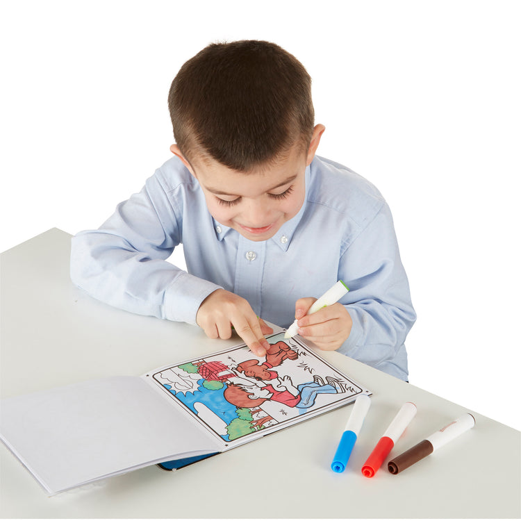 A child on white background with The Melissa & Doug On the Go Magicolor Coloring Pad: Adventure - 18 Coloring Pages and 4 Markers