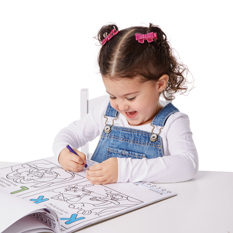 A kid playing with The Melissa & Doug Alphabet Activity Sticker Pad for Coloring, Letters (250+ Stickers)