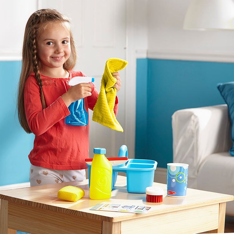 A kid playing with The Deluxe Cleaning & Laundry Play Set