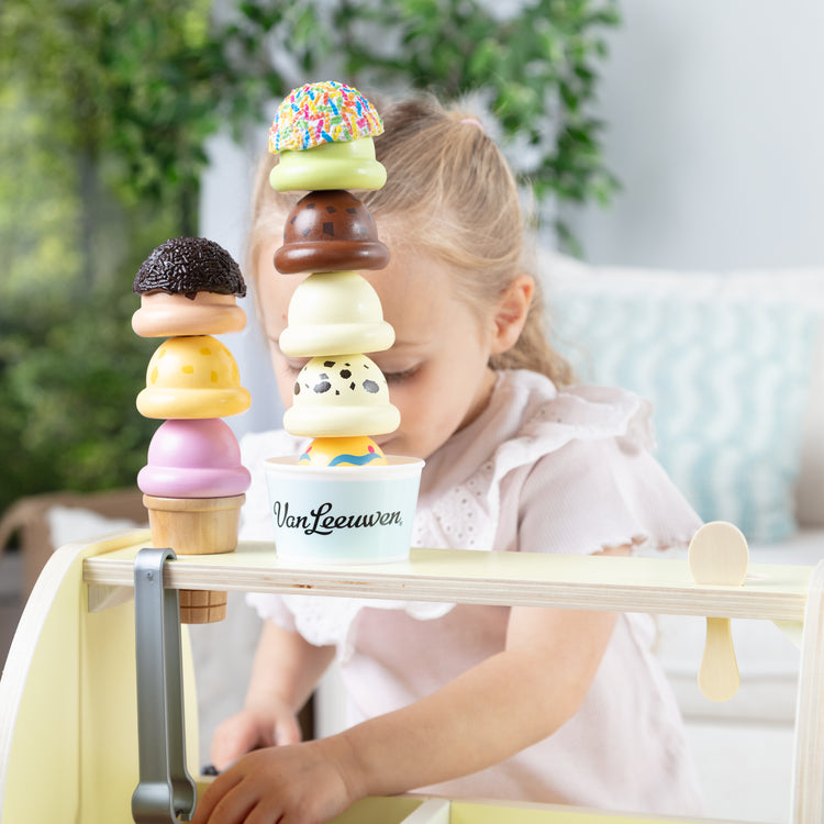 A kid playing with The Van Leeuwen Scoop Shop Ice Cream Play St
