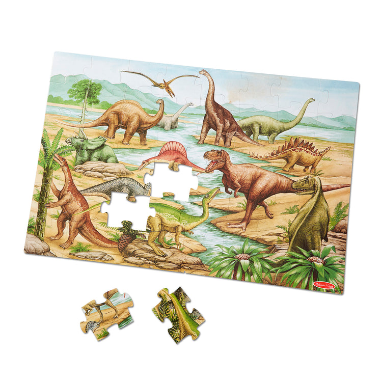 The loose pieces of The Melissa & Doug Dinosaurs Floor Puzzle - 48 Pieces (2 Feet x 3 Feet Assembled)